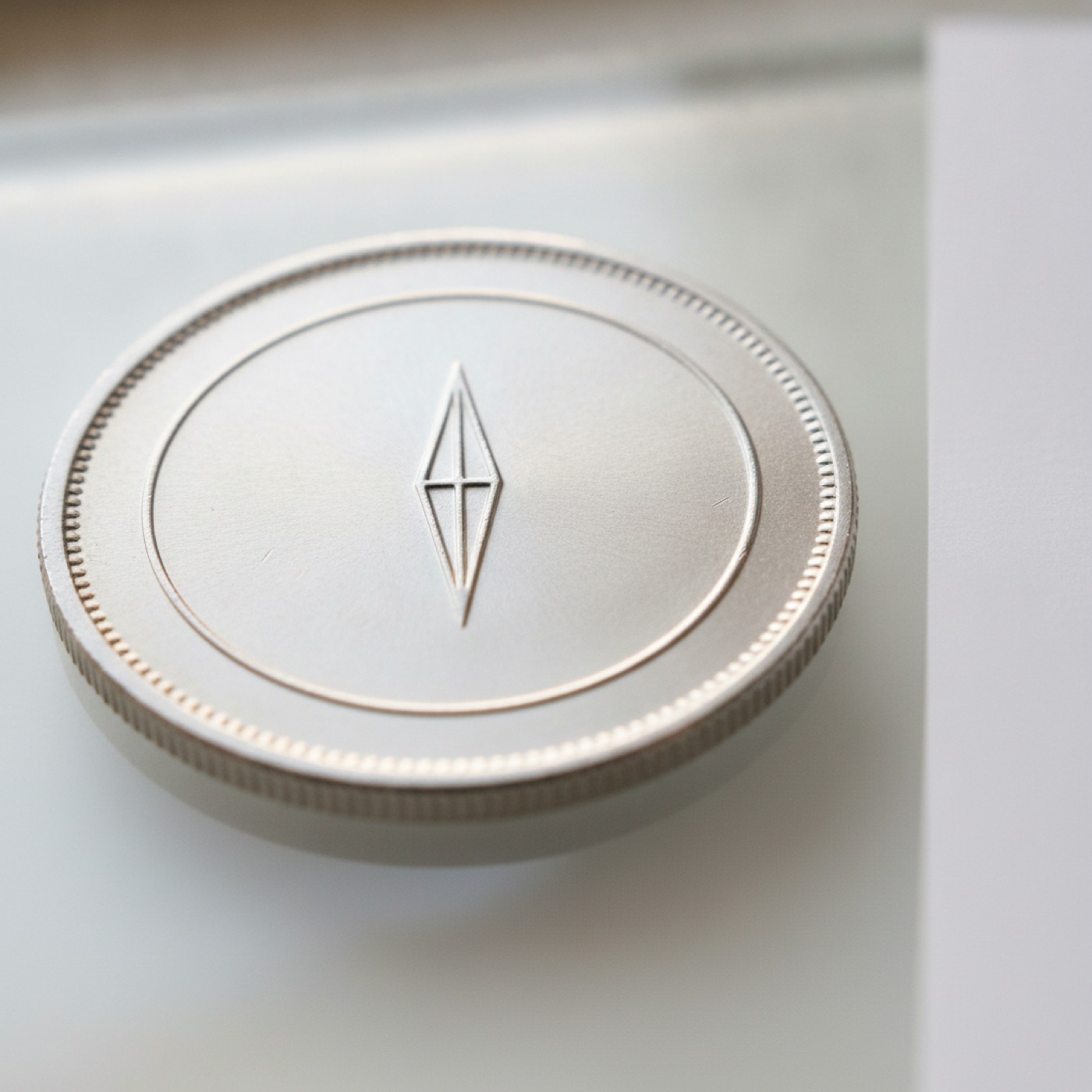 Close-up of an Ethereum coin showing the faceted diamond logo in sharp detail